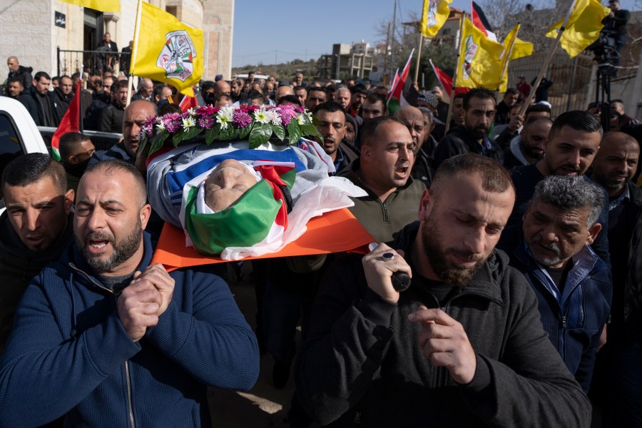 FILE - Mourners carry the body of Omar Assad, during his funeral in the West Bank village of Jiljiliya, north of Ramallah, Thursday, Jan. 13, 2022. Israeli leaders on Sunday, April 21, 2024, harshly criticized an expected decision by the U.S. to impose sanctions on a unit of ultra-Orthodox soldiers in the Israeli military. The unit came under heavy American criticism in 2022 after the elderly Palestinian-American man was found dead shortly after he was detained at a West Bank checkpoint. (AP Photo/Nasser Nasser, File)