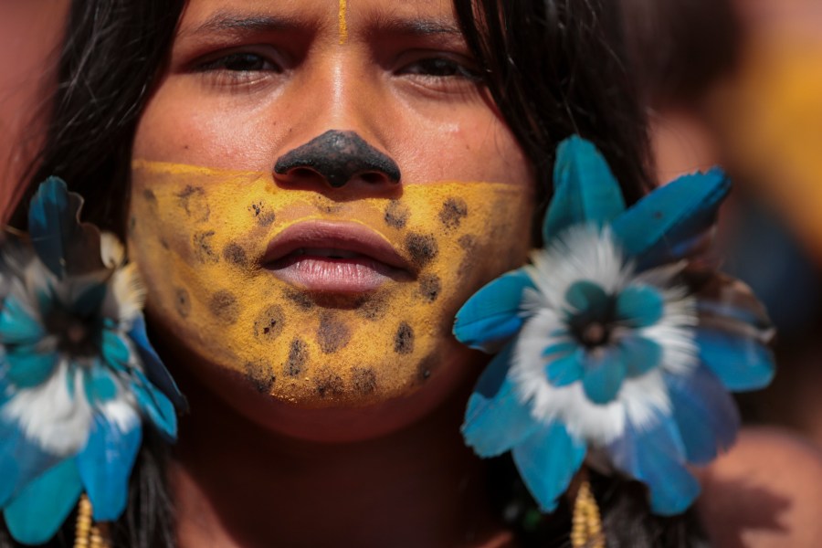 An Indigenous woman attends the 20th annual Free Land Indigenous Camp in Brasilia, Brazil, Monday, April 22, 2024. The 7-day event aims to show the unity of Brazil's Indigenous peoples in their fight for the demarcation of their lands and their rights. (AP Photo/Luis Nova)