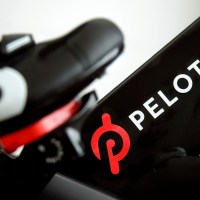 FILE - This Nov. 19, 2019 file photo shows the logo on a Peloton bike in San Francisco. Peloton is cutting about 400 jobs worldwide as part of a restructuring effort and its CEO Barry McCarthy is stepping down after two years as the company continues to work on turning around its business. Peloton Interactive Inc. said Thursday, May 2, 2024 that the job reductions amount to approximately 15% of its global headcount. (AP Photo/Jeff Chiu, File)