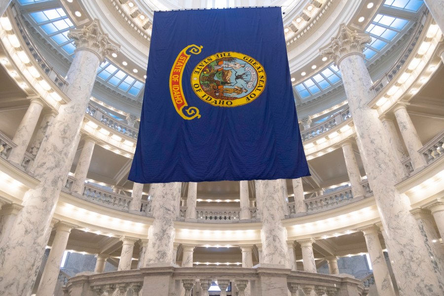 FILE - The Idaho state flag hangs in the State Capitol in Boise, Idaho, Jan. 9, 2023. Idaho voters are heading to the polls to decide primaries for the U.S. House and state legislature. (AP Photo/Kyle Green, File)
