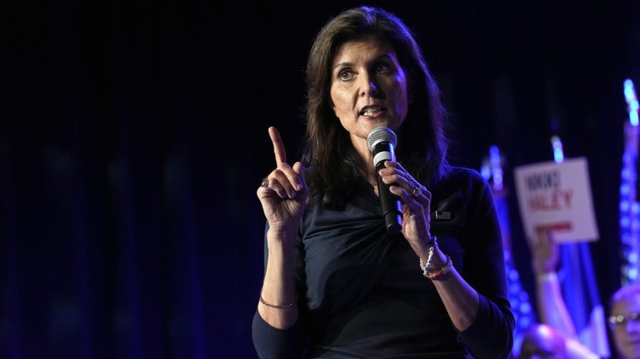 Nikki Haley gestures while speaking at a campaign event.