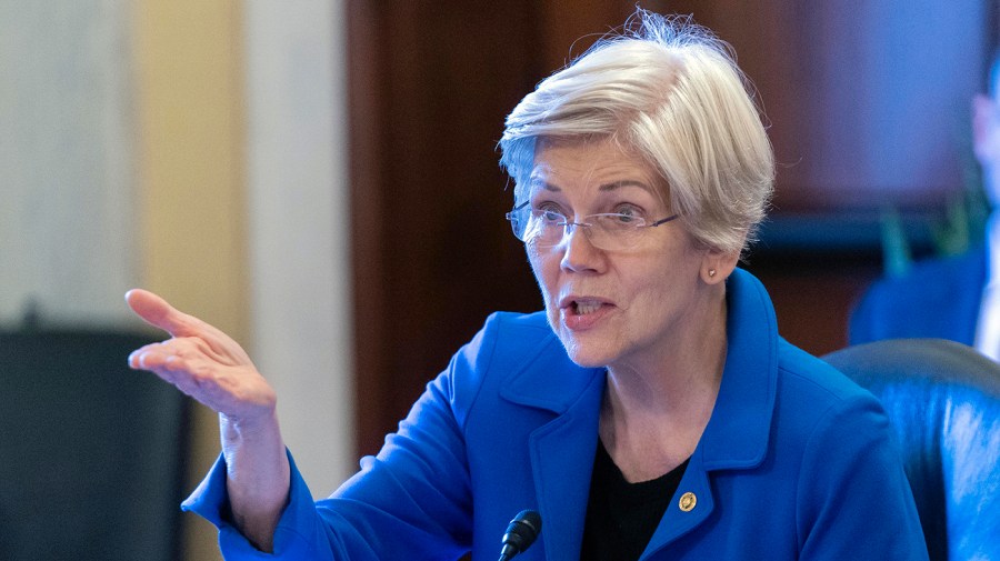 Senator Elizabeth Warren gestures while speaking during a congressional hearing.