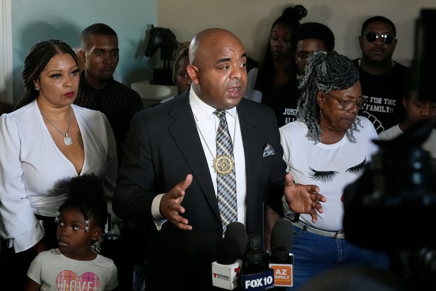 Rev. Jarrett Maupin, joined by several alleged victims of civil rights violations, speaks during a news conference, Friday, June 14, 2024, in Phoenix. Maupin, a Phoenix activist known for working with victims alleging police brutality, discusses the Department of Justice probe, accusing the police force in the nation's fifth-largest city of discriminating against Black, Hispanic and Native American people, unlawfully detaining homeless people and using excessive force. (AP Photo/Ross D. Franklin)