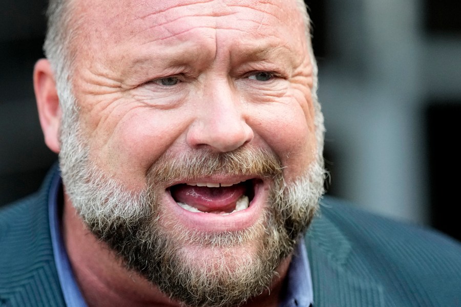 Right-wing conspiracy theorist Alex Jones speaks to the media after arriving at the federal courthouse for a hearing in front of a bankruptcy judge Friday, June 14, 2024, in Houston. The judge is expected to rule on whether to liquidate Jones' assets to help pay the $1.5 billion he owes for his false claims that the Sandy Hook Elementary School shooting was a hoax. (AP Photo/David J. Phillip)