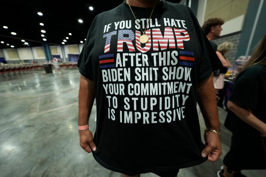 A person displays a shirt before Republican presidential candidate former President Donald Trump speaks at his birthday celebration, hosted by Club 47, in West Palm Beach, Fla., Friday, June 14, 2024. (AP Photo/Gerald Herbert)