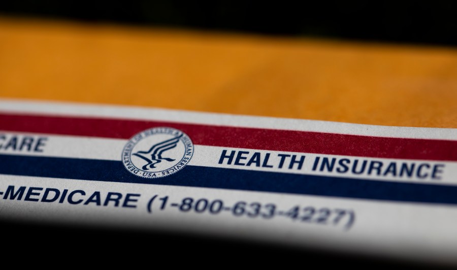 FILE - A shadow is seen across a Medicare card on June 10, 2024, in Portland, Ore. Majorities of Americans favor forgiving all or some of an individual's medical debt if the person is facing hardships, according to a new poll from the University of Chicago Harris School of Public Policy and The Associated Press-NORC Center for Public Affairs Research. (AP Photo/Jenny Kane)