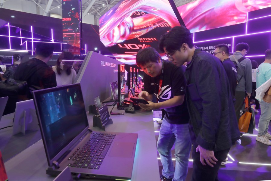 Visitors review new computer products during the Computex Taipei exhibition, one of the world's largest computer and technology expos, in Taipei, Taiwan, Tuesday, June 4, 2024. A suspected Chinese state-sponsored hacking group have predominantly stepped up its targeting of Taiwanese organizations, particularly those in sectors such as government, education, technology and diplomacy, according to cybersecurity intelligence company Recorded Future. (AP Photo/Chiang Ying-ying, File)