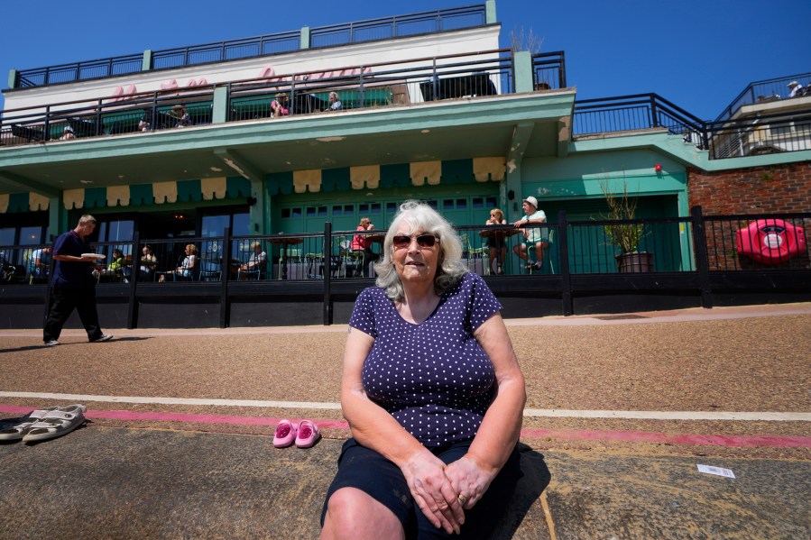 Dorothy Carr sits on the beachfront in Clacton-On-Sea, England, Friday, June 21, 2024. Like many others in the town, Carr feels a deep sense of disillusionment with the governing Conservatives. Instead, she says she is probably voting for the anti-immigration Reform UK party in next week's national election. (AP Photo/Kirsty Wigglesworth)