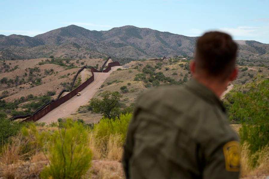 Border patrol agent Pete Bidegain looks from a hilltop on the U.S. side of the US-Mexico border in Nogales, Ariz. on Tuesday, June 25, 2024. (AP Photo/Jae C. Hong, Pool)