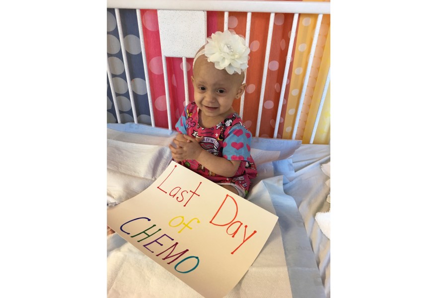 Giada Demma, 1-year-old, sits in a pediatric hospital bed at NYU Langone Medical Center in New York on Oct. 17, 2017, the last day she was scheduled to undergo chemotherapy for cancer. Her family had a seamstress make the Disney hospital gown Giada is wearing. But seeing the child wearing a drab hospital issued-gown on a different date helped inspired Giada’s cousin Guiliana Demma to learn to sew and make brightly colored, kid-themed hospital gowns for hospitalized children. Since 2021, Giuliana Demma and her sister Audrina have made and donated 1,800 hospital gowns and several hundred kid-sixed pillows to children in hospitals in 36 states and Uganda. (Melissa Demma via AP)