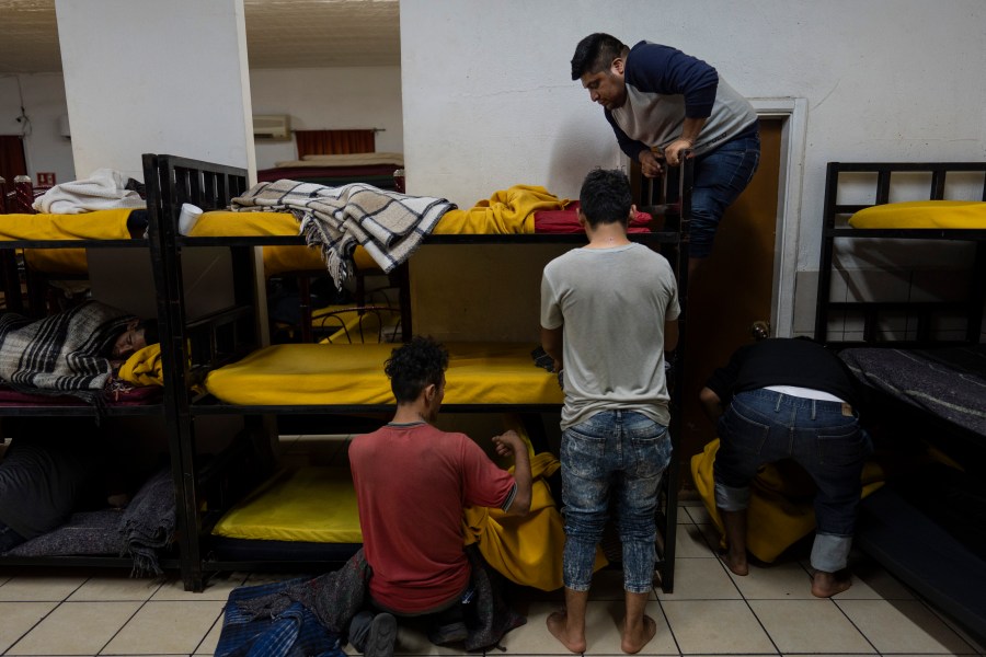 Migrants, mostly Mexican nationals recently deported from the U.S., prepare to settle into their bunk beds for the night at the San Juan Bosco migrant shelter in Nogales, Mexico, Tuesday, June 25, 2024. (AP Photo/Jae C. Hong)