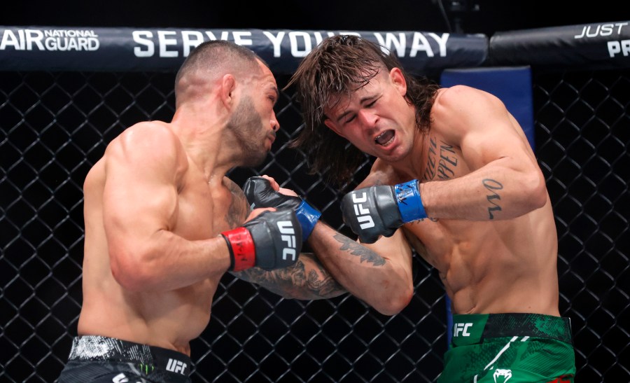 Dan Ige, left, punches Diego Lopes during a 165-pound catchweight mixed martial arts bout at UFC 303, Saturday, June 29, 2024, in Las Vegas. Ige replaced Brian Ortega, who withdrew from the bout due to illness. (Steve Marcus/Las Vegas Sun via AP)