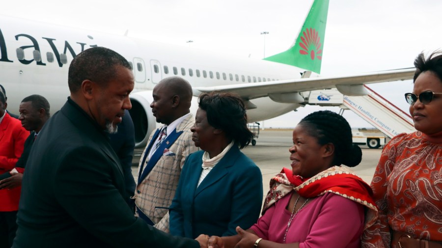 Malawi Vice President Saulos Chilima, left, greets government officials upon his return from South Korea in Lillongwe, Sunday, June 9, 2024. A military plane carrying Malawi's vice president and nine others went missing Monday and a search was underway, the president's office said. The plane carrying 51-year-old Vice President Saulos Chilima left the capital, Lilongwe, but failed to make its scheduled landing at Mzuzu International Airport about 370 kilometers (230 miles) to the north around 45 minutes later. (AP Photo)