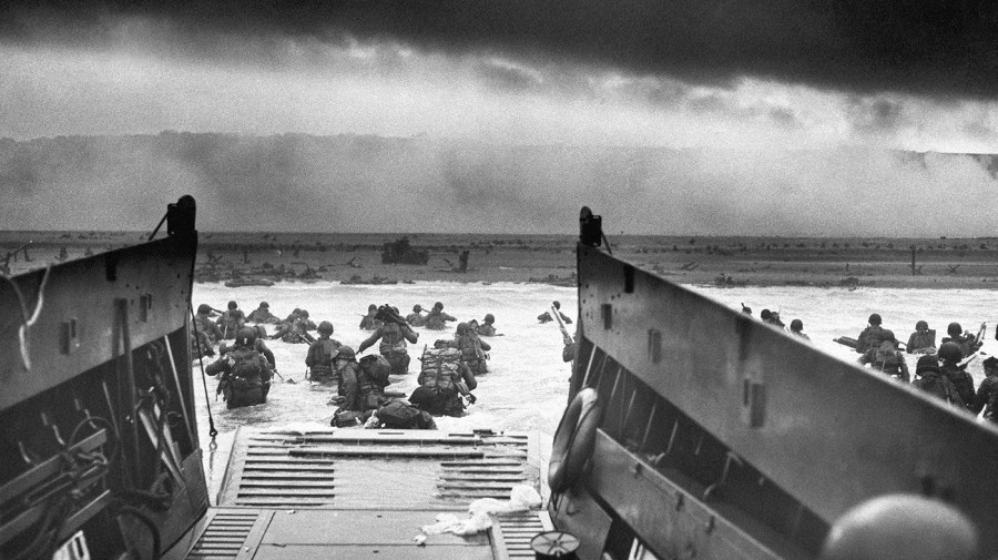 This historical photo shows soldiers on the beach on D-Day.