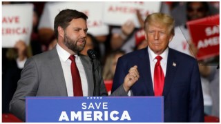 JD Vance and former President Trump stand on stage together at a campaign event.