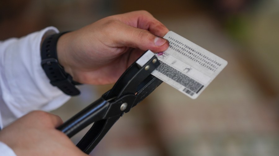 An electoral official marks the ID of a person who already voted during general elections in Mexico City, Sunday, June 2, 2024. (AP Photo/Fernando Llano)