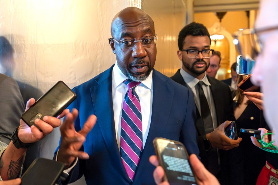 FILE - Sen. Raphael Warnock, D-Ga., speaks with reporters, Sept. 28, 2023, in Washington. Senior Democratic figures rallied publically around President Joe Biden on Sunday, June 30, 2024, amid private angst within the party about Thursday's debate performance. Warnock said during NBC's "Meet The Press," there had been "more than a few Sundays, when I wish I had preached a better sermon, but after the sermon was over it was my job to embody the message, to show up for the people that I serve. And that's what Joe Biden has been doing his entire life." (AP Photo/Alex Brandon, File)