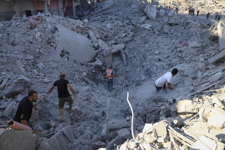 Palestinians search for bodies and survivors in the rubble of a residential building destroyed in an Israeli airstrike in Khan Younis, Gaza Strip, Wednesday, July 3, 2024. (AP Photo /Jehad Alshrafi)