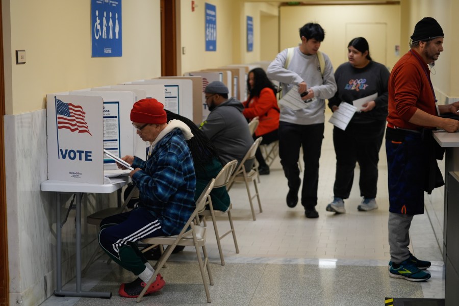 FILE - People vote and turn in their ballots at City Hall in San Francisco, Tuesday, March 5, 2024. Slavery, same-sex marriage and shoplifting are among the 10 statewide ballot measures California voters will consider in November. (AP Photo/Eric Risberg,File)