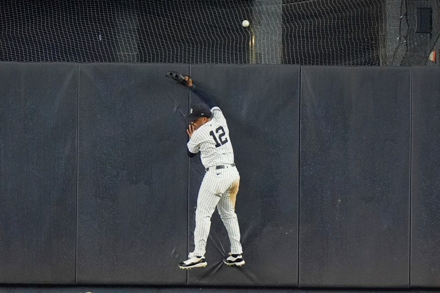 New York Yankees' Trent Grisham (12) chases a two-run home run hit by Boston Red Sox's Ceddanne Rafaela during the 10th inning of a baseball game, Friday, July 5, 2024, in New York. (AP Photo/Frank Franklin II)