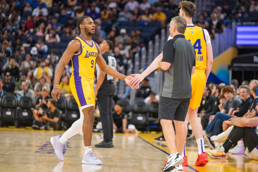 Los Angeles Lakers guard Bronny James (9) shakes hands with center Colin Castleton (14) during the first half of an NBA summer league basketball game against the Sacramento Kings in San Francisco, Saturday, July 6, 2024. (AP Photo/Nic Coury)