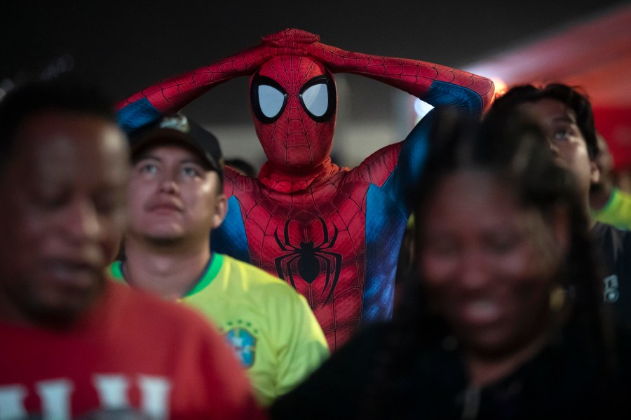 A soccer fan dressed as Spiderman reacts watches Brazil play Uruguay in a Copa America quarterfinal match on a screen set up for fans on Copacabana Beach in Rio de Janeiro, Sunday, July 7, 2024. Brazil lost in a penalty shootout and Uruguay qualified for the semifinals. (AP Photo/Bruna Prado)