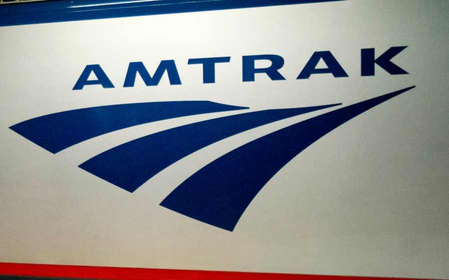 FILE - An Amtrak logo is displayed on a train at 30th Street Station on Feb. 6, 2014, in Philadelphia. Amtrak service between New York and Boston has been suspended for the rest of the day, the rail service announced Saturday, July 6, 2024. (AP Photo/Matt Rourke, File)