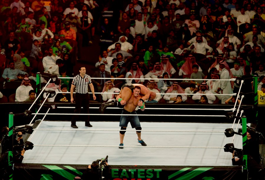 FILE - World Wrestling Entertainment star John Cena carries professional wrestler and WWE Executive Vice President Paul "Triple H" Levesque during their match of the "Greatest Royal Rumble" event in Jiddah, Saudi Arabia, April 27, 2018. Cena announced Saturday, July 6, 2024, that he will retire from professional wresting next year after two decades in the ring. (AP Photo/Amr Nabil, File)