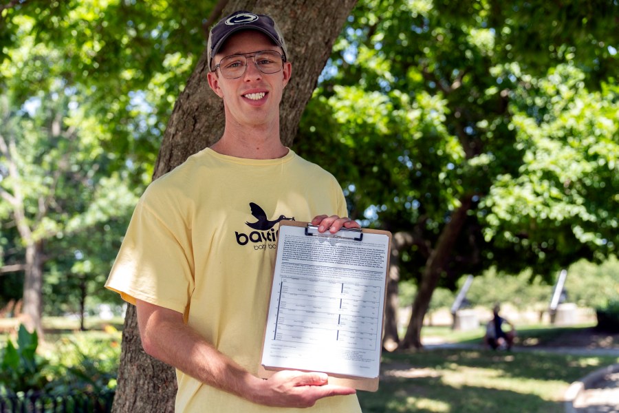 Nate Golden, president of the Maryland Child Alliance, poses for a portrait with a petition form for the Baltimore Baby Fund, Wednesday, July 3, 2024, in Baltimore. (AP Photo/Stephanie Scarbrough)