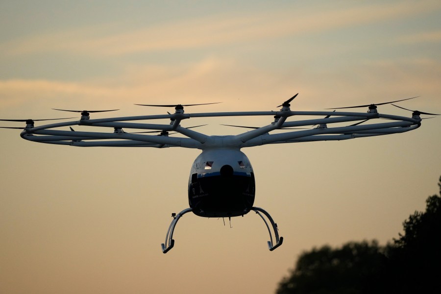 A Volocopter aircraft carries out a test flight on the last day of the 2024 Olympics with a sunrise demonstration at the 2024 Summer Olympics, Sunday, Aug. 11, 2024, in Versailles, France. (AP Photo/Mosa'ab Elshamy)