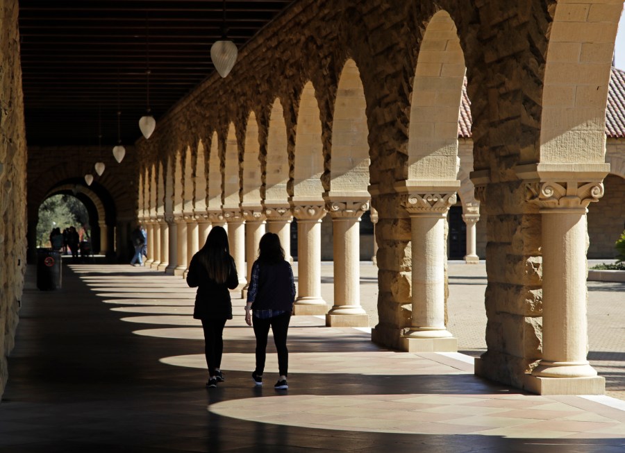 FILE - Students walk on the Stanford University campus on March 14, 2019, in Stanford, Calif. (AP Photo/Ben Margot, File)