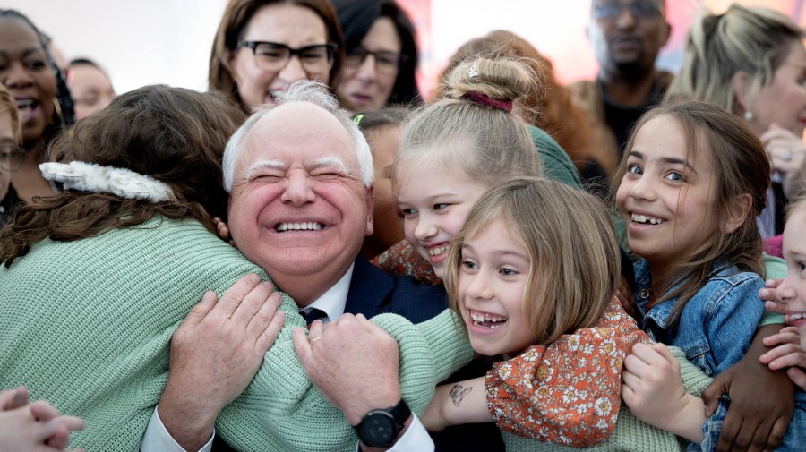 Minnesota Gov. Tim Walz gets a huge hug from students.