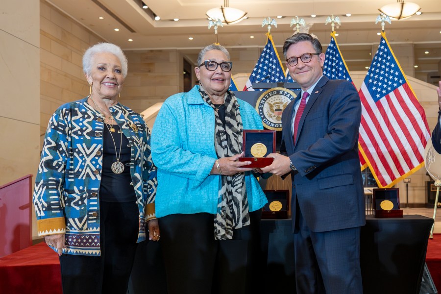 House Speaker Mike Johnson, R-La., center, presents a Congressional Gold Medal posthumously to Joylette Hylick, left, and Katherine Moore, daughters of Katherine Johnson, the Black NASA mathematician featured in the movie "Hidden Figures," at the Capitol in Washington, Wednesday, Sept. 18, 2024. (AP Photo/J. Scott Applewhite)