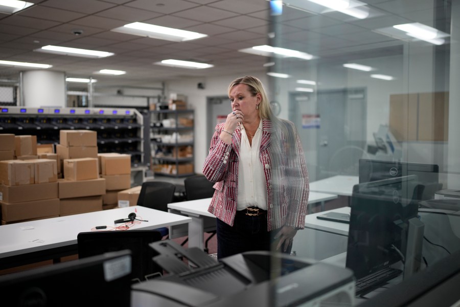 Cari-Ann Burgess, interim Registrar of Voters for Washoe County, Nev., pauses while helping prepare the office for elections, Sept. 20, 2024, in Reno, Nev. (AP Photo/John Locher)