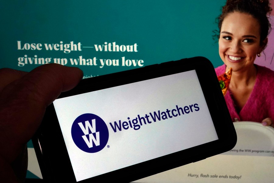 FILE - This image shows the logo of WeightWatchers on a mobile phone, and the company's website, in New York, Tuesday, March 7, 2023. (AP Photo/Richard Drew, File)