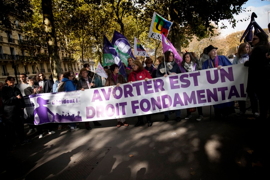 Demonstrators hold a banner reading: Abortion is a fundamental right, as they march in support of the right to abortion for women across the world, in Paris, Saturday, Sept. 28, 2024. (AP Photo/Christophe Ena)