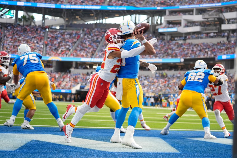 Los Angeles Chargers quarterback Justin Herbert throws under pressure from Kansas City Chiefs cornerback Trent McDuffie (22) during the first half of an NFL football game Sunday, Sept. 29, 2024, in Inglewood, Calif. (AP Photo/Ashley Landis)