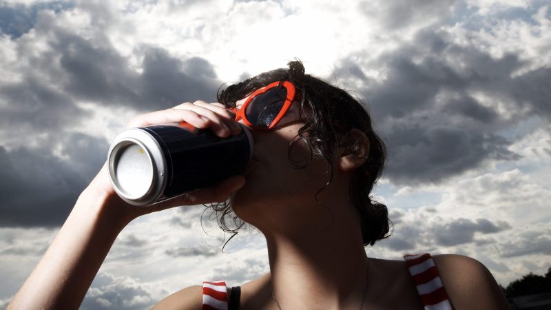 Girl drinking from a can