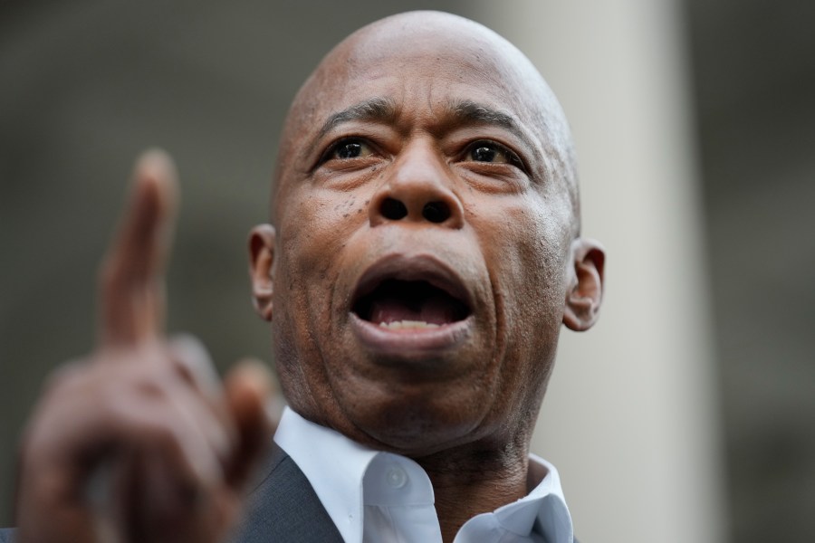 New York City Mayor Eric Adams speaks while surrounded by faith leaders and other supporters during a rally and prayer vigil on the steps of City Hall in New York, Tuesday, Oct. 1, 2024. (AP Photo/Seth Wenig)