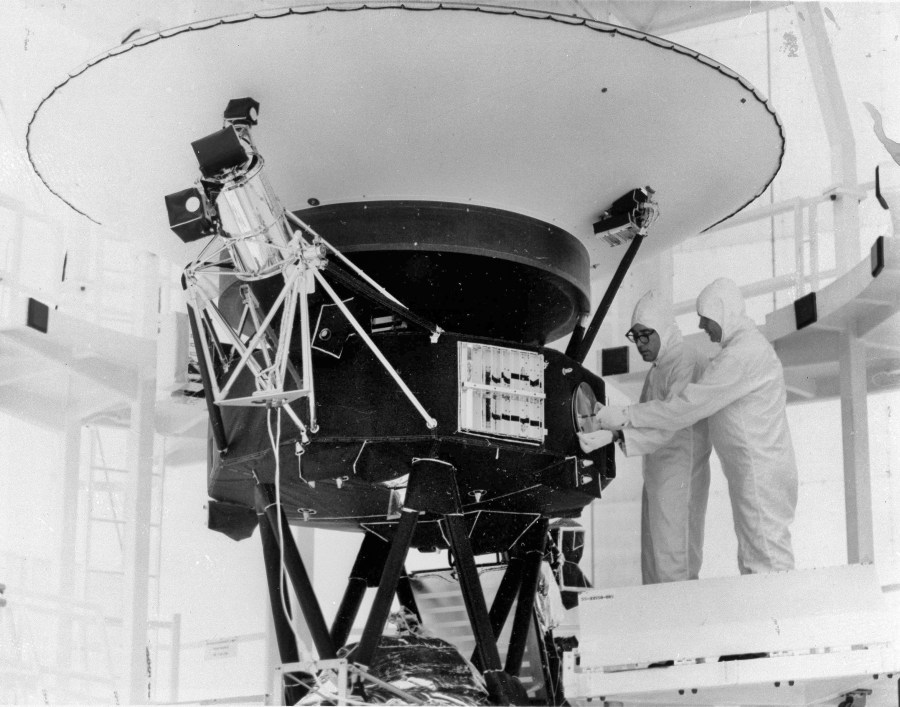 FILE - This photo provided by NASA shows the "Sounds of Earth" record being mounted on the Voyager 2 spacecraft in the Safe-1 Building at the Kennedy Space Center, Fla. Aug. 4, 1977. (AP Photo/NASA, File)