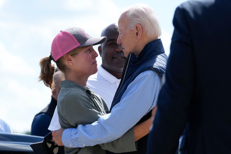 President Joe Biden talks with Asheville Mayor Esther Manheimer, as he arrives at Greenville-Spartanburg International Airport in Greer, S.C., Wednesday, Oct. 2, 2024, to survey damage from Hurricane Helene. (AP Photo/Susan Walsh)