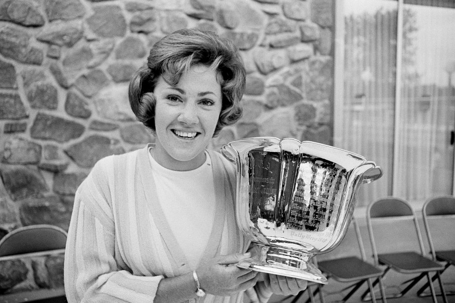 FILE - Susie Maxwell holds the silver trophy after winning the 36th annual Women's Western golf tournament, June 14, 1965, in Chicago. (AP Photo/Larry Stoddard, File)