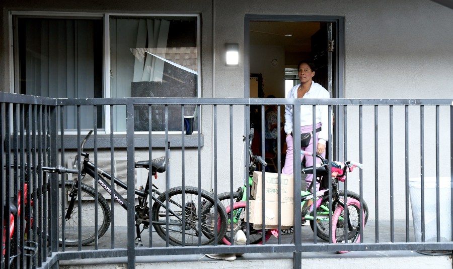 Sofia Roca stands at the entry to her apartment in in Aurora, Colorado, on March 29, 2024. In the U.S., she realizes reports she’d heard back in Colombia about earning $1,000 a week were likely hyperbole. (AP Photo/Thomas Peipert)