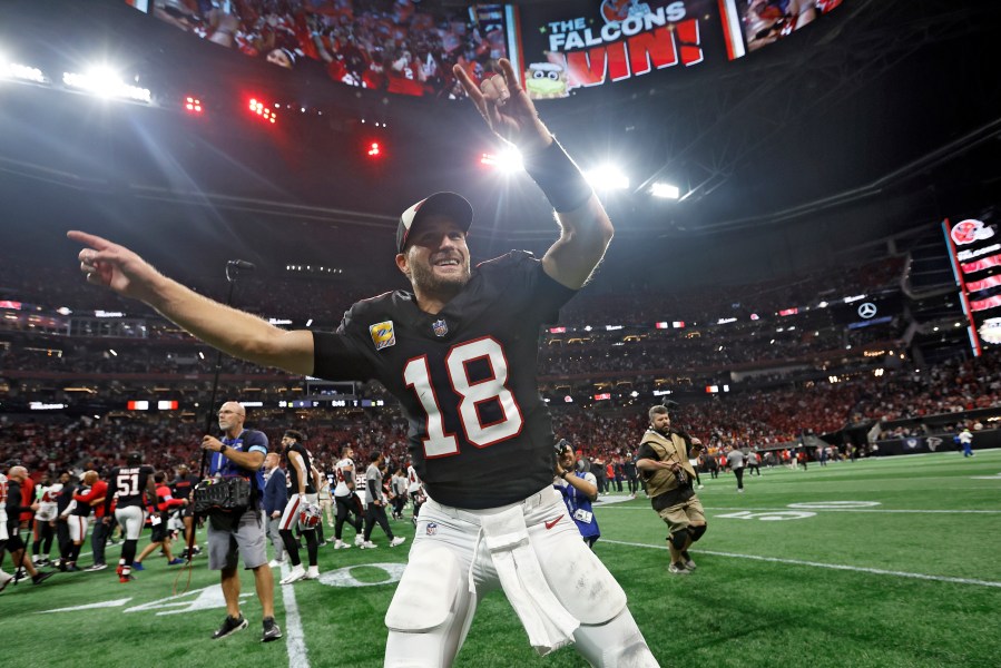 Atlanta Falcons quarterback Kirk Cousins (18) celebrates with the fans after the team defeated the Tampa Bay Buccaneers during overtime in an NFL football game Thursday, Oct. 3, 2024, in Atlanta. (AP Photo/Butch Dill)