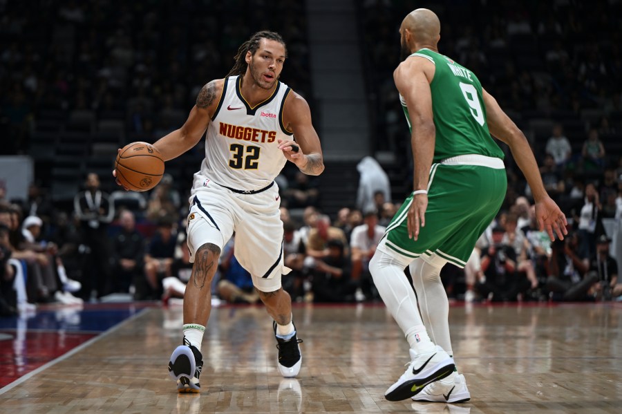 Boston Celtics Derrick White guards Denver Nuggets Aaron Gordon during a preseason game between Boston Celtics and Denver Nuggets in Abu Dhabi, United Arab Emirates, Friday, Oct. 4, 2024. (AP Photo/Martin Dokoupil)