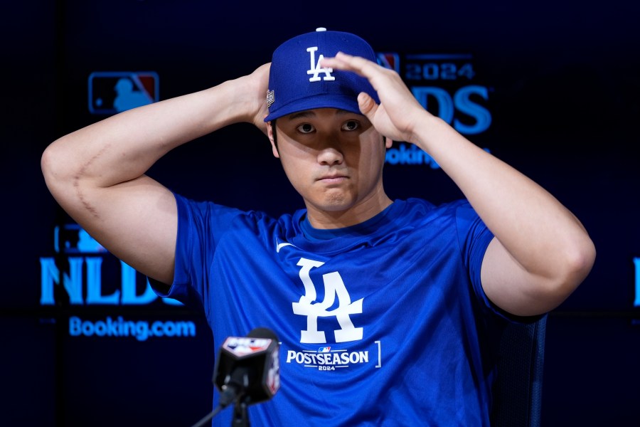 Los Angeles Dodgers' Shohei Ohtani speaks to reporters in a press conference in preparation for Game 1 of a baseball NL Division Series against the San Diego Padres in Los Angeles, Friday, Oct. 4, 2024. (AP Photo/Ashley Landis)