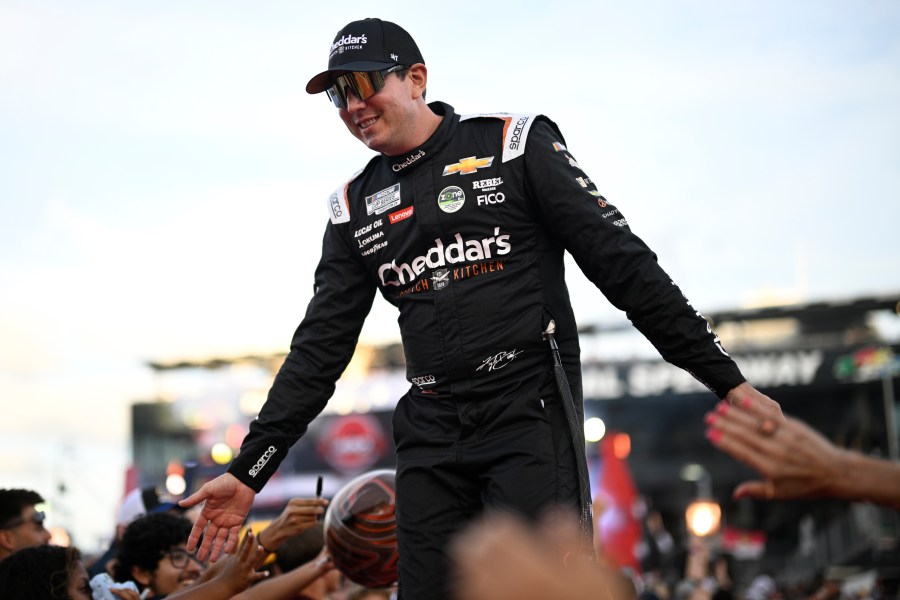 FILE - Kyle Busch interacts with spectators while walking down a runway during driver introductions before a NASCAR Cup Series auto race at Daytona International Speedway, Aug. 24, 2024, in Daytona Beach, Fla. (AP Photo/Phelan M. Ebenhack, File)