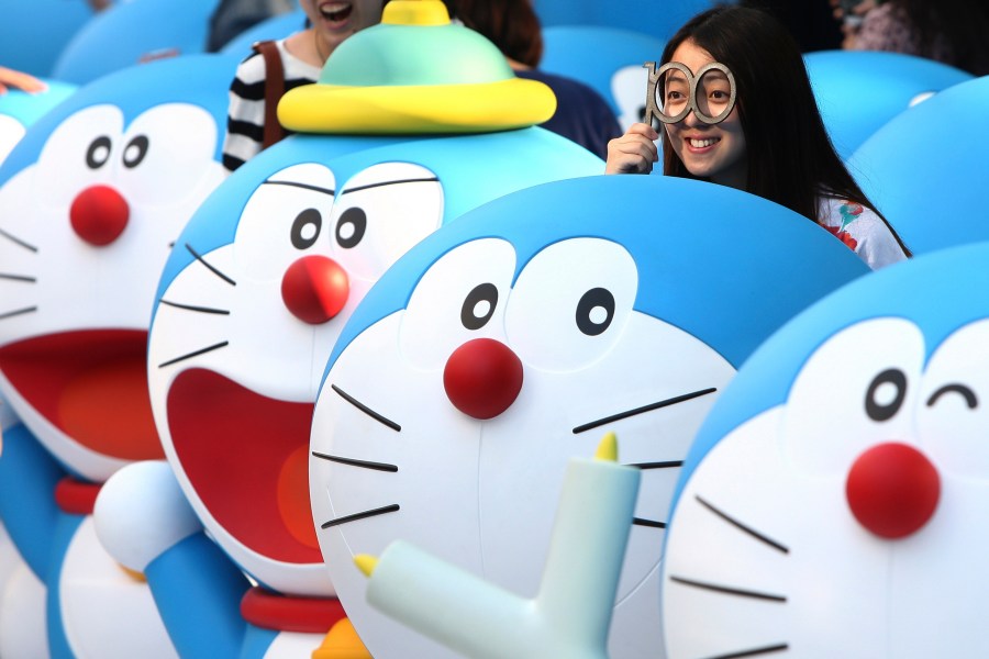 FILE - Models of Doraemon, one of Japan's most popular manga and anime characters, are displayed in Shanghai on April 28, 2013. (AP Photo/File)