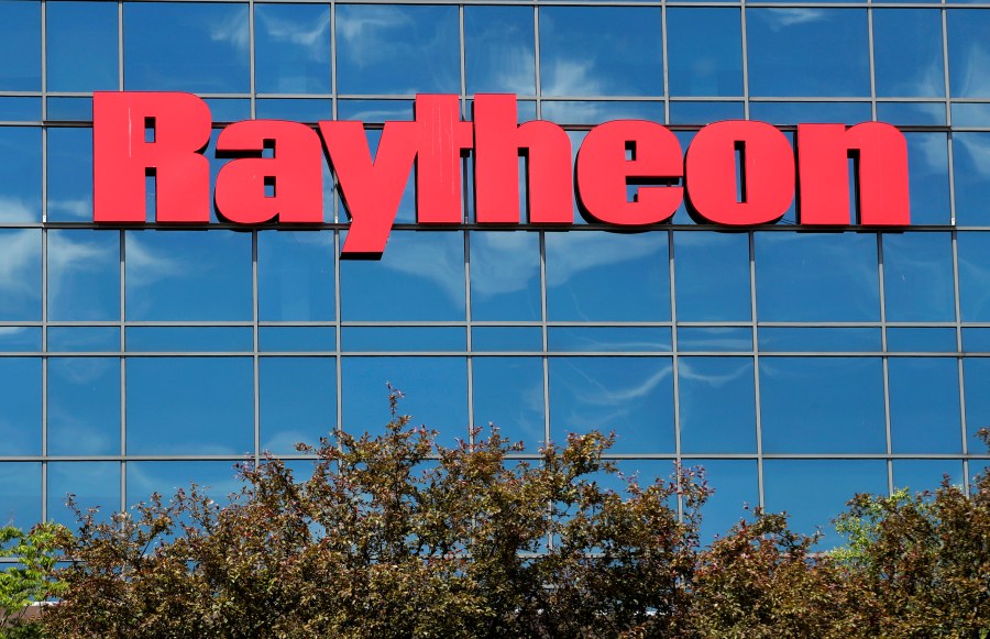 FILE - The sky is reflected on the facade of Raytheon's Integrated Defense Systems facility, Monday, June 10, 2019, in Woburn, Mass. (AP Photo/Elise Amendola, File)