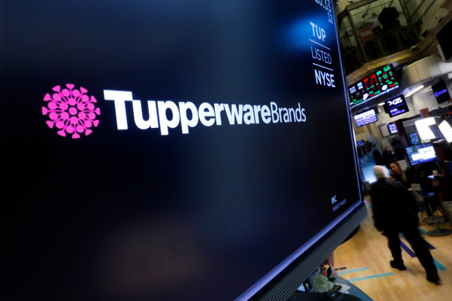 FILE - The logo for Tupperware Brands appears above a trading post on the floor of the New York Stock Exchange on Oct. 30, 2019. (AP Photo/Richard Drew)